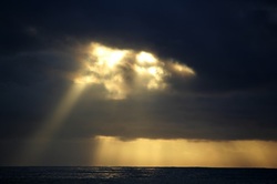 Sunshine breaking through storm clouds